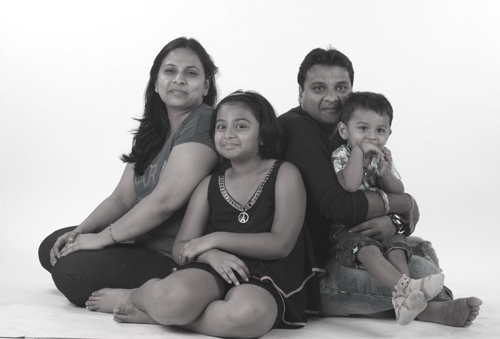 Family of 4 sitting B&W